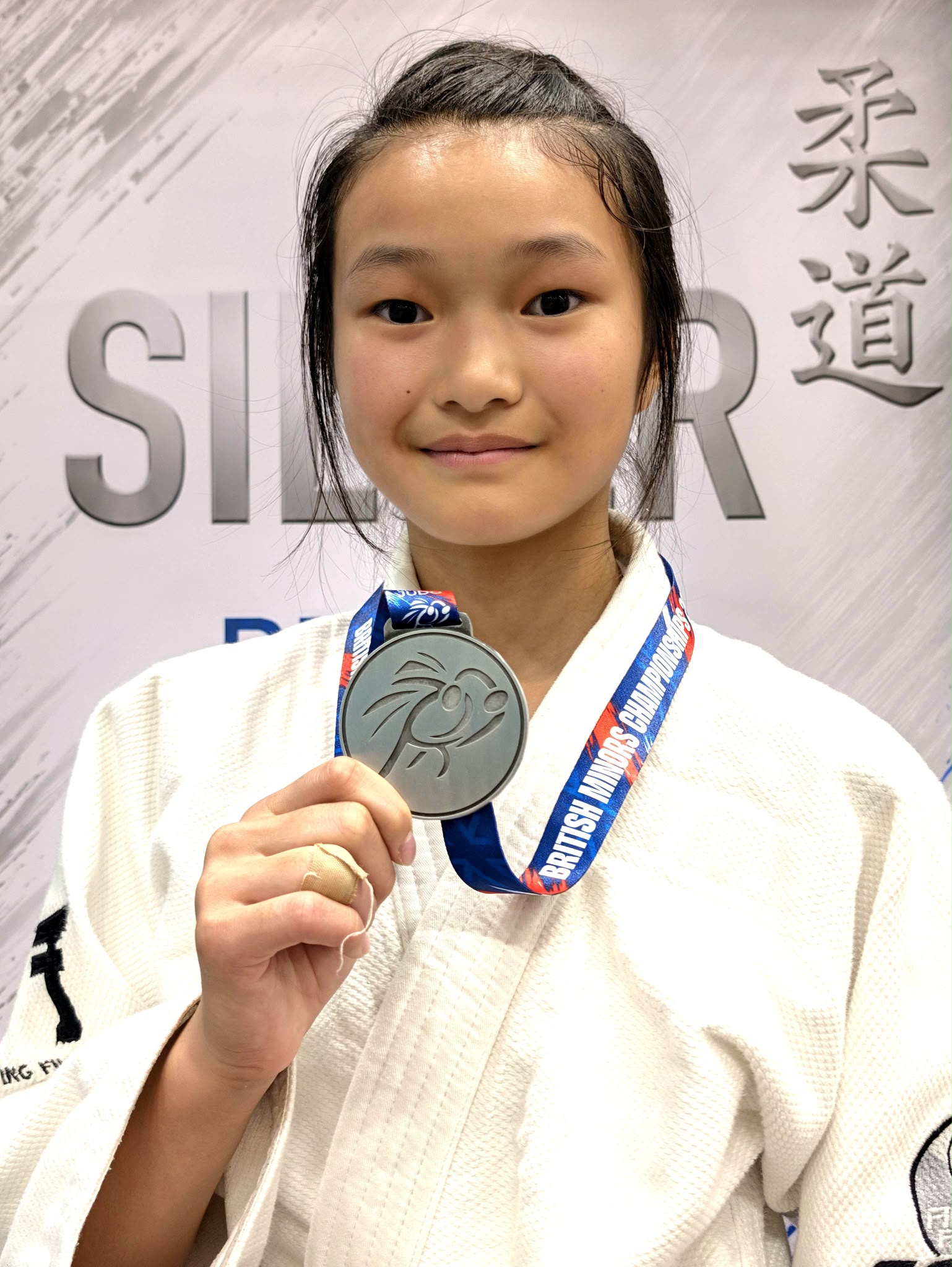 Maisie Chang with her silver medal at the British Minors Judo Championships