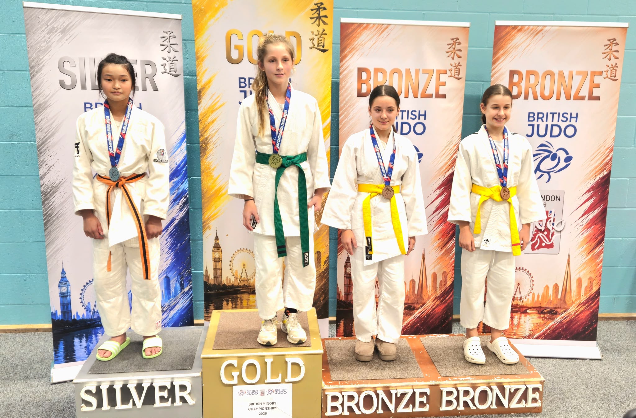 Maisie Chang on the silver-medal position at the British Minors Judo Championships podium