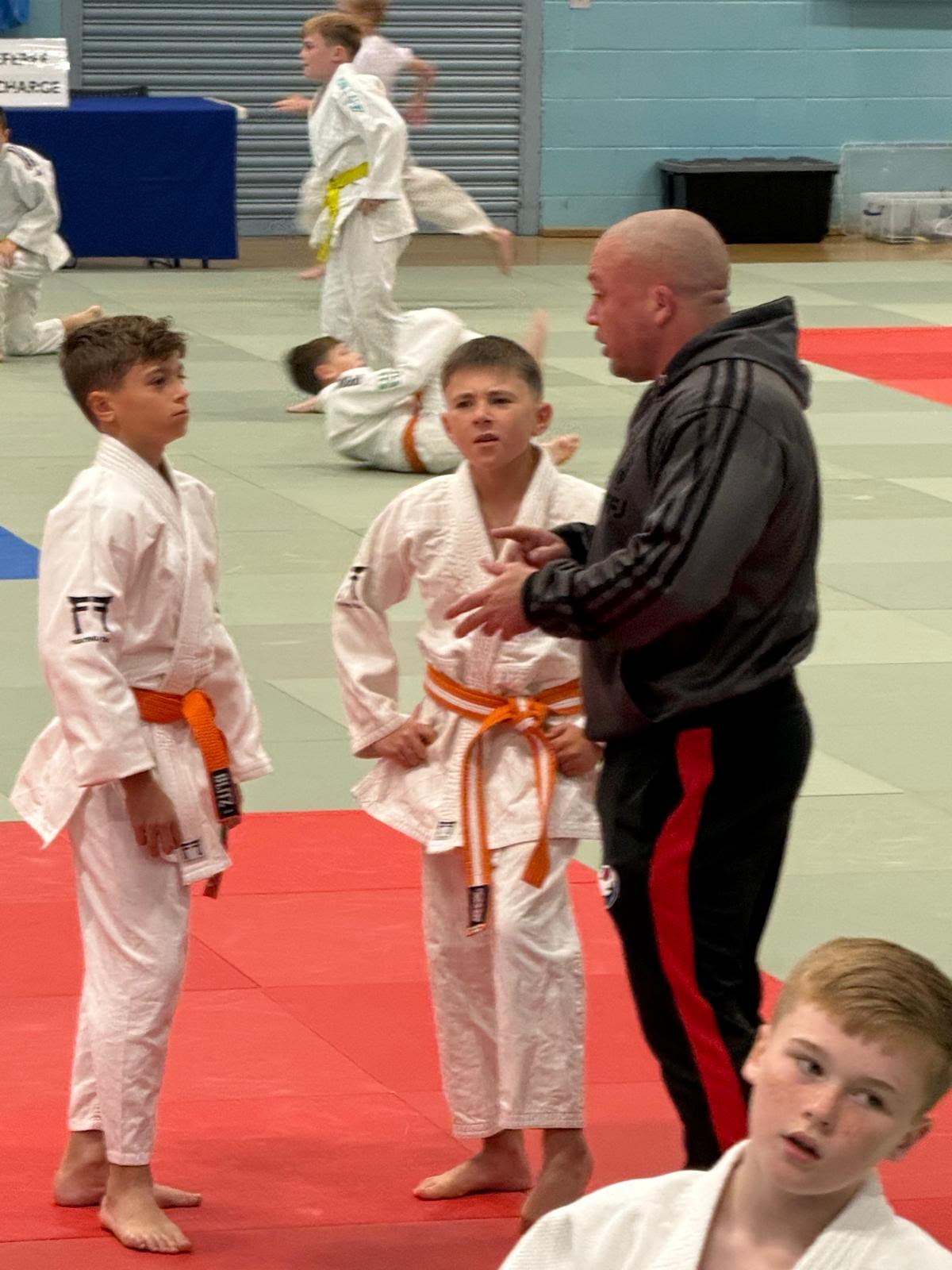 Fighting Fitness Judo Pathway Squad members listening to coaching between contests at the British Minors Judo Championships
