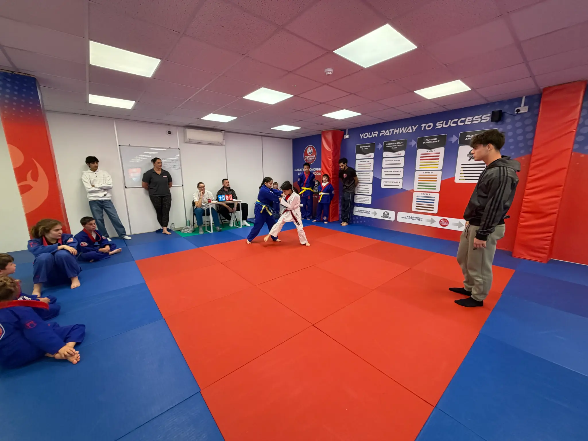 Two children competing on the mat during the Team Festival
