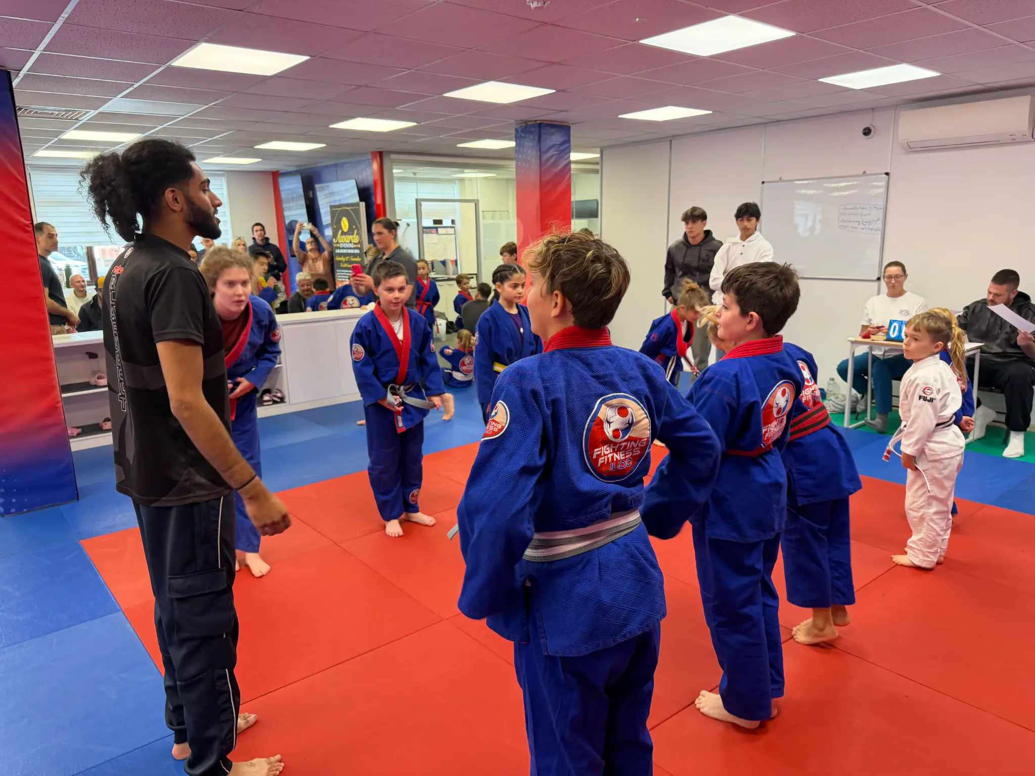 Young team members listening to their coach between Team Festival battles