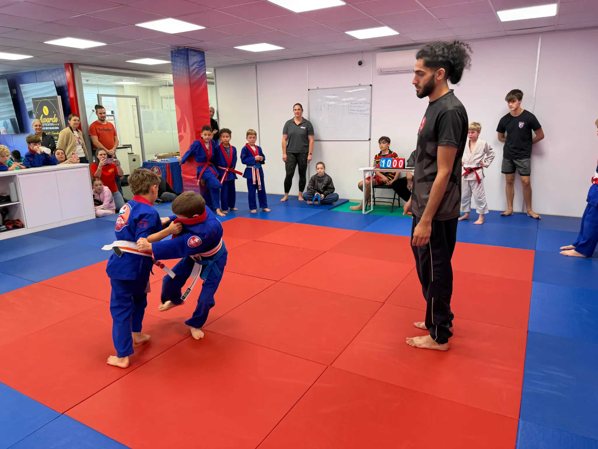 Young judoka preparing to compete with a coach nearby
